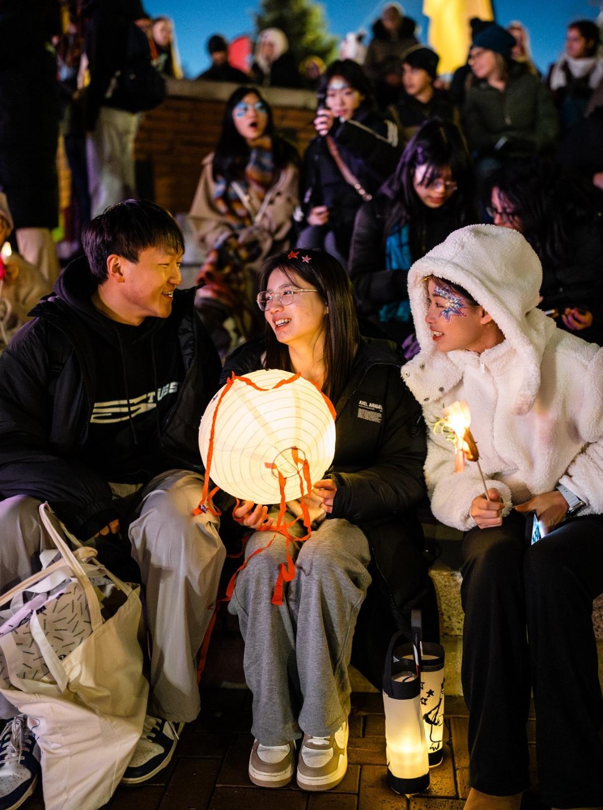Students holding lanterns